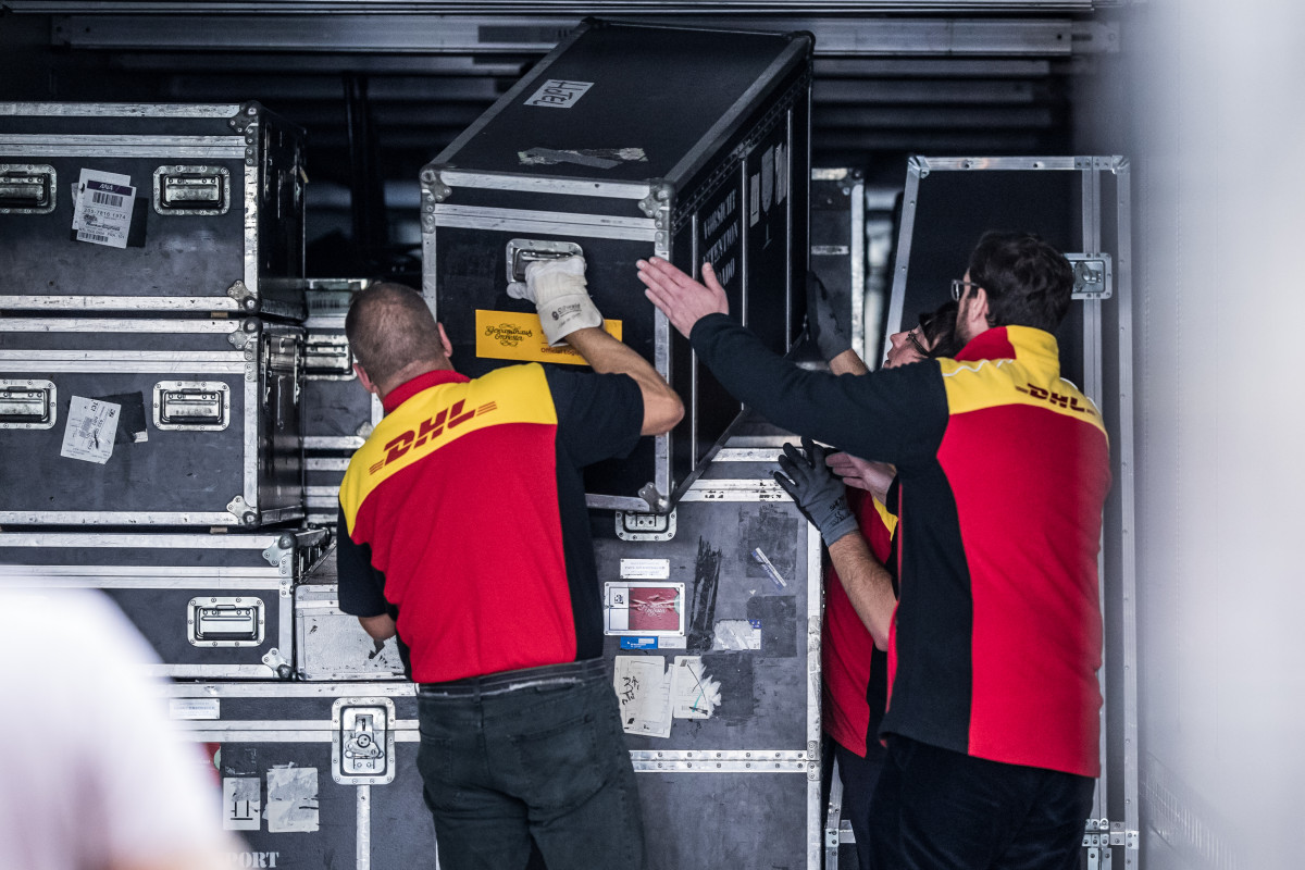 DHL staff unload the valuable instruments and other equipment of the Gewandhausorchester