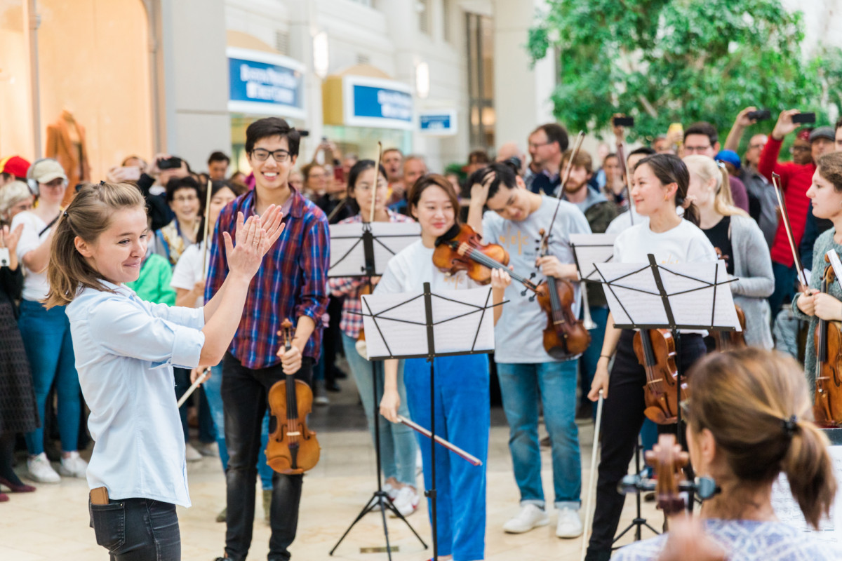 Russian-born Anna Rakitina, Boston Symphony Orchestra's newest assistant conductor, thanks her flash mob volunteers for a great performance.