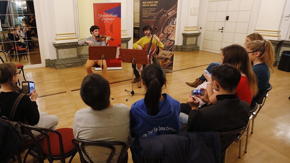 The youngsters listen to the concert, capturing it on their smartphones. (Photo Credits: DHL)