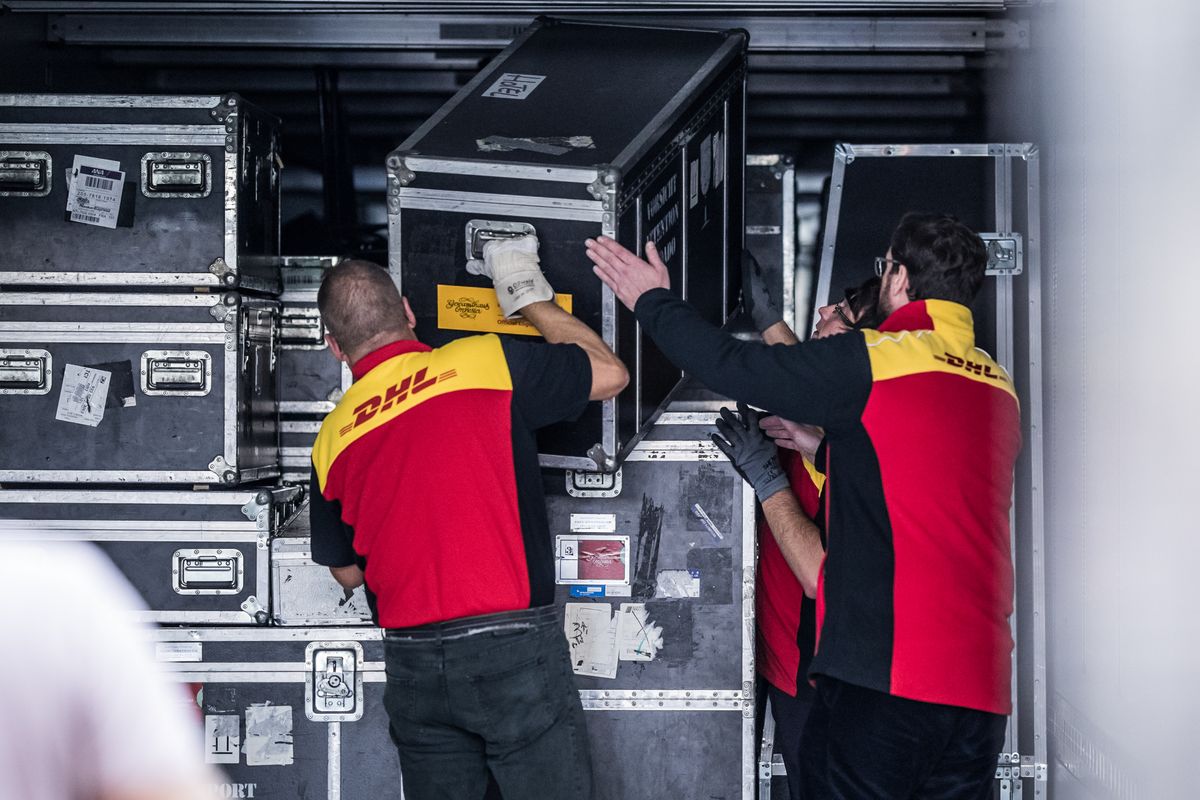 DHL staff unload the valuable instruments and other equipment of the Gewandhausorchester