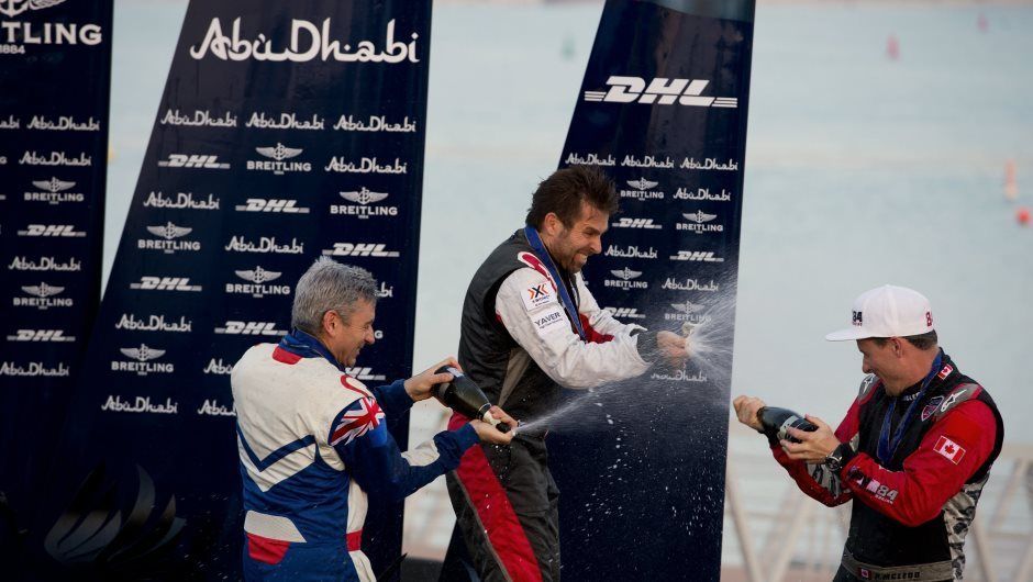 Winners celebrate with traditional champagne shower